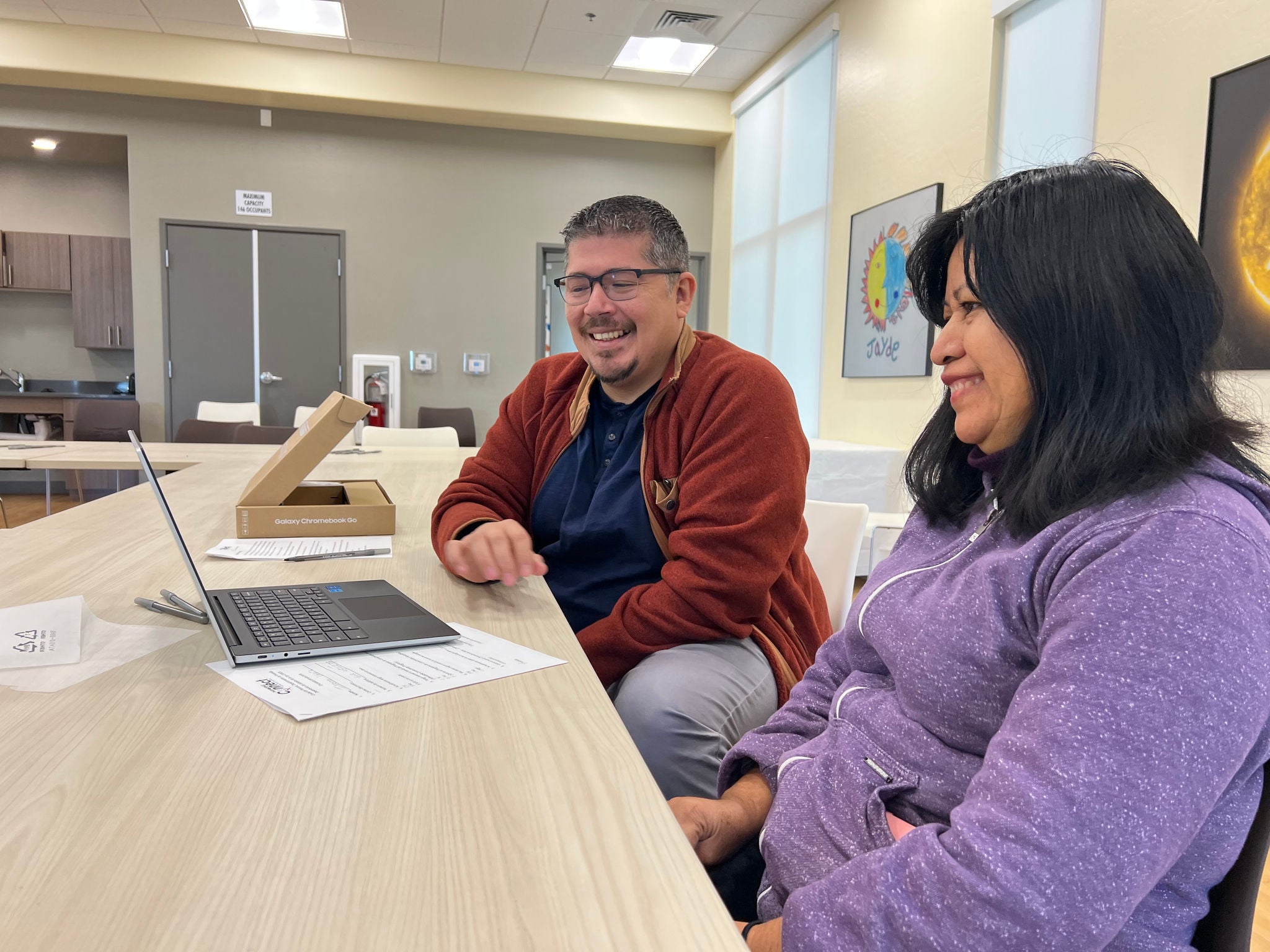 PHXConnect program Digital Navigator and resident looking at laptop