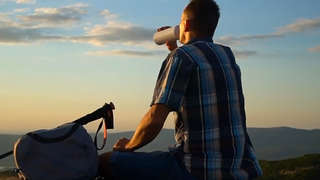 man at sunset drinking water