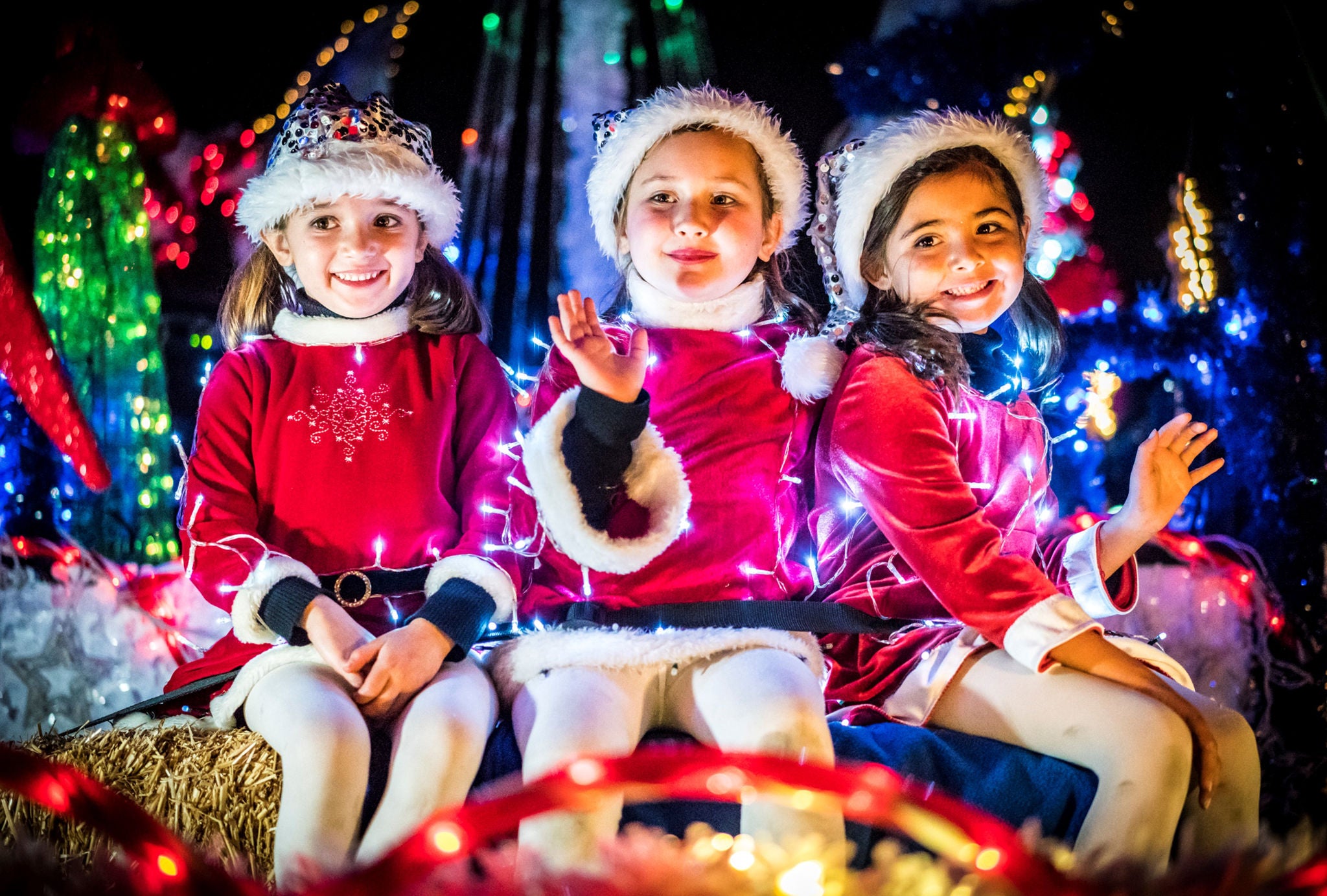 A photo of two smiling kids at the electric light parade