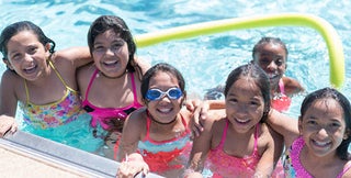 Six girls play in a City of Phoenix swimming pool.