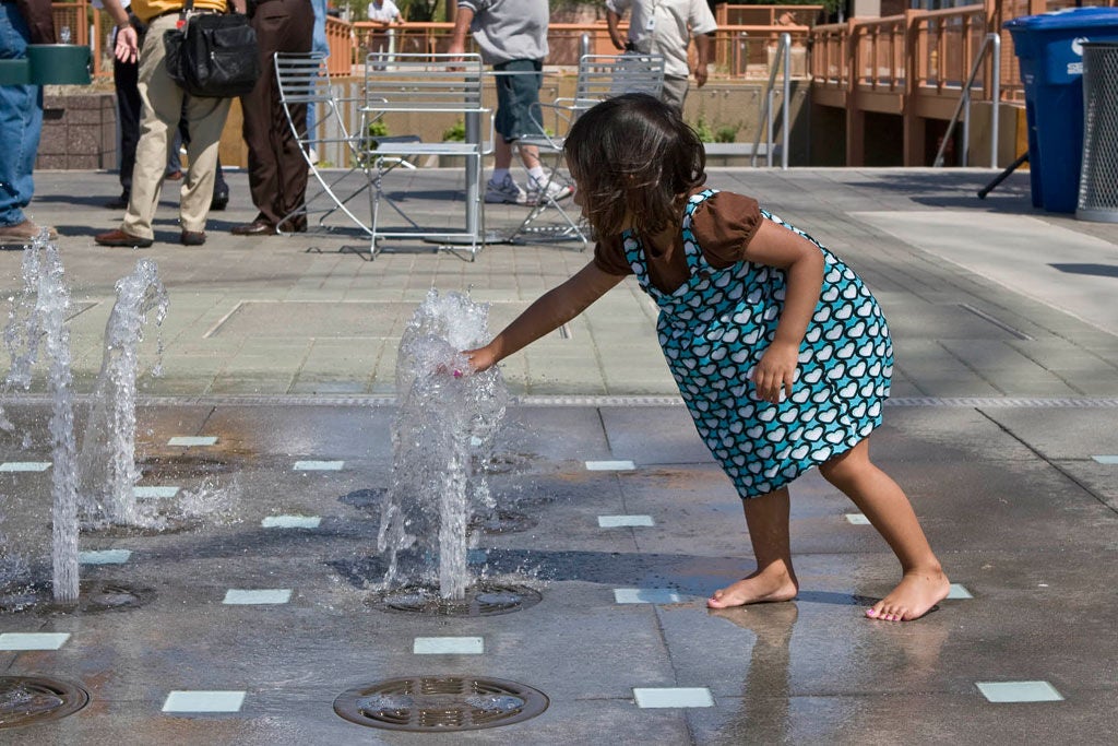 Little Girl Playing in CityScape's Water Feature
