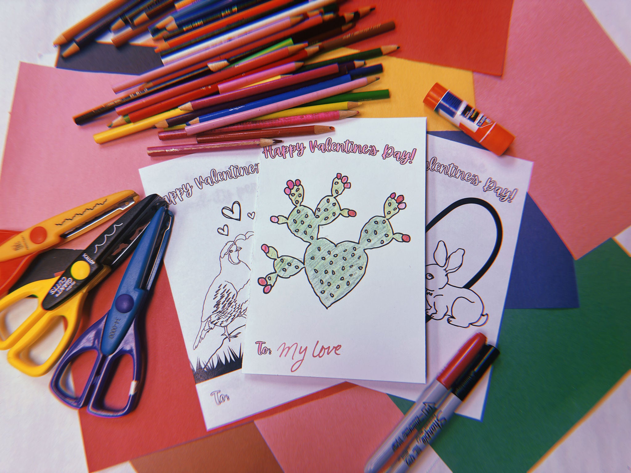 Desert themed Valentine's Day card surrounded by different craft materials 