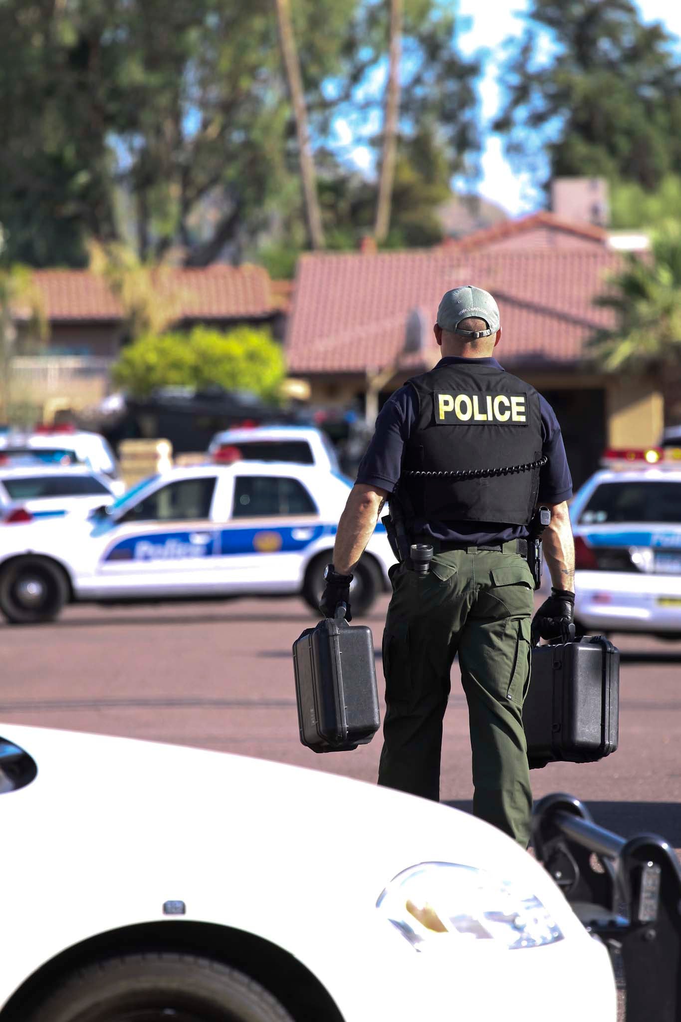 Officers in front of policy cruiser