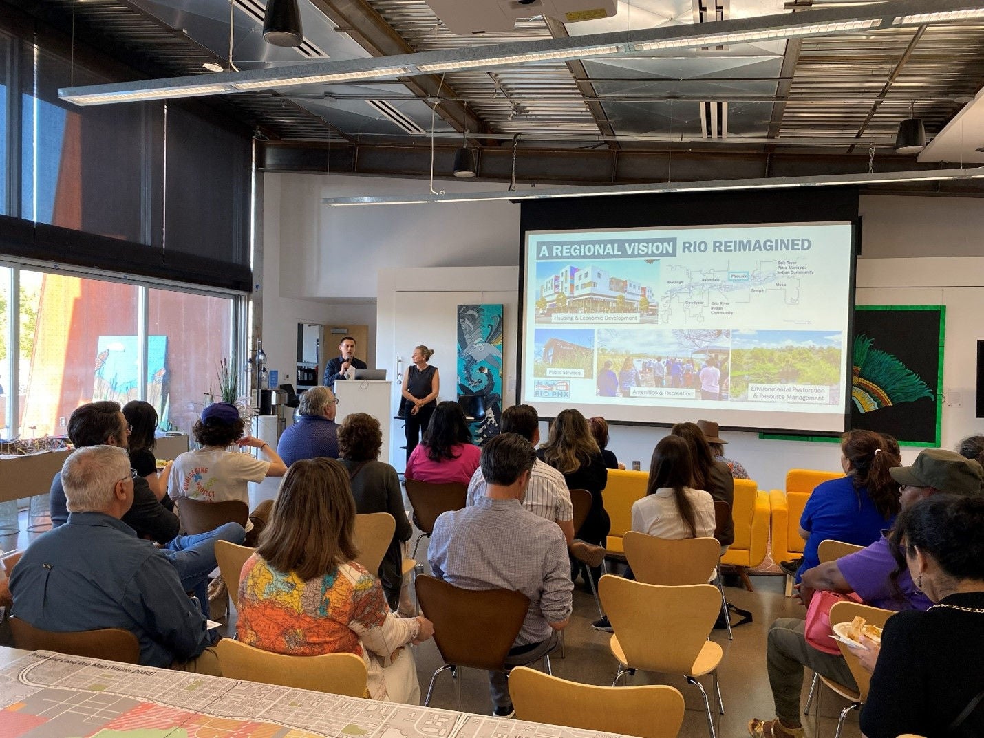 Photo of a group of residents listening to a presentation on RIO Reimagined