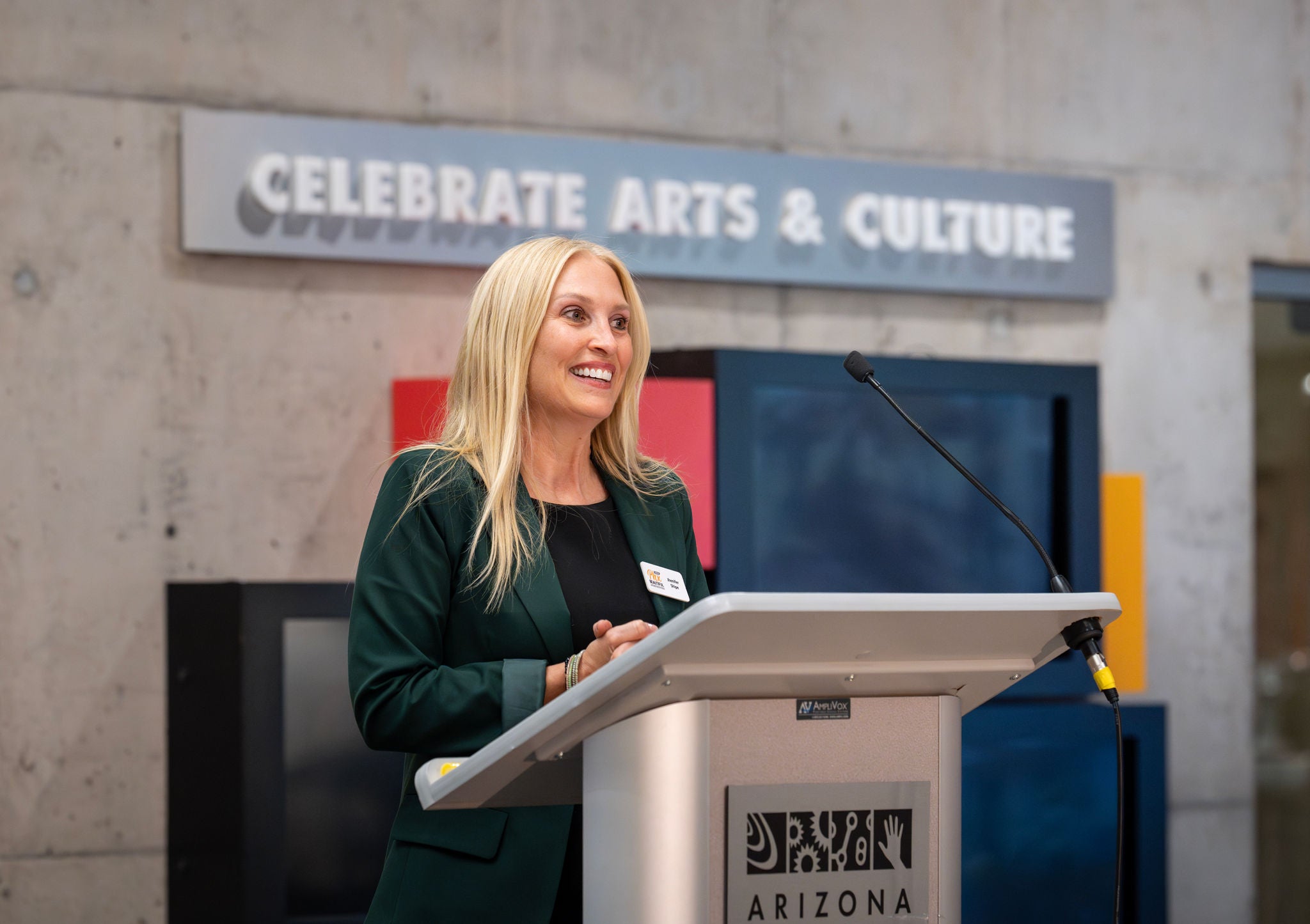 A speaker at the podium in the atrium of the Arizona Science Center