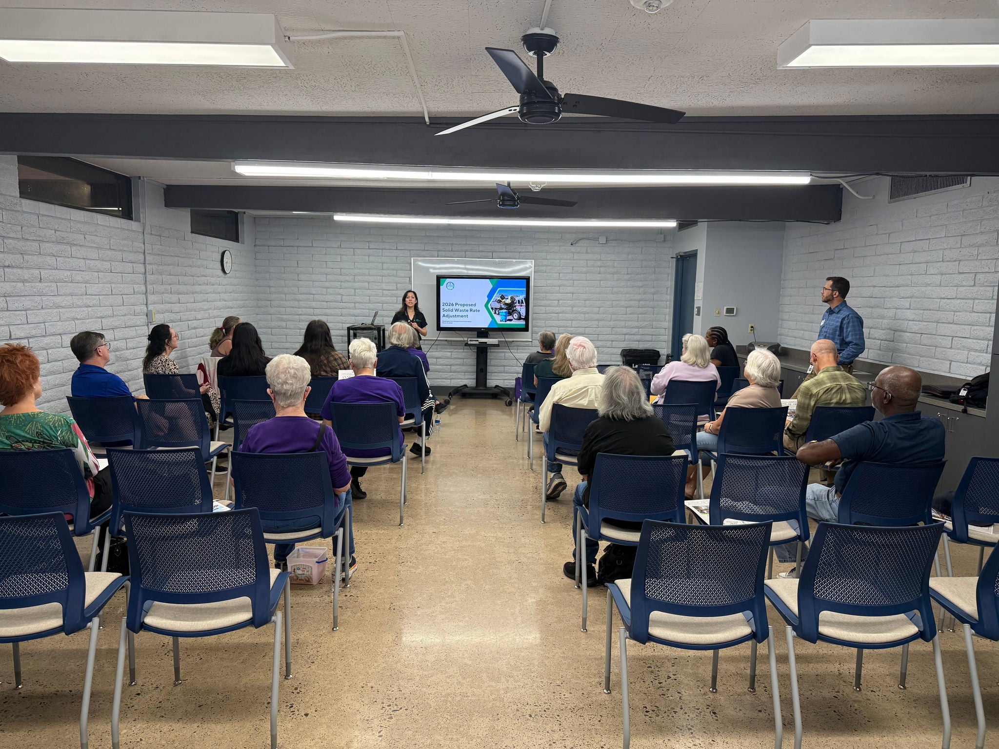 Public Works staff gives a presentation about the solid waste rate proposal to residents at a community meeting at the Washington Activity Center.