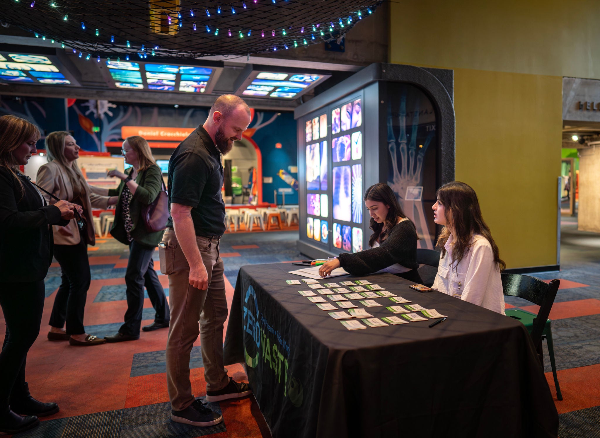 Guests grab nametags at the check-in table.