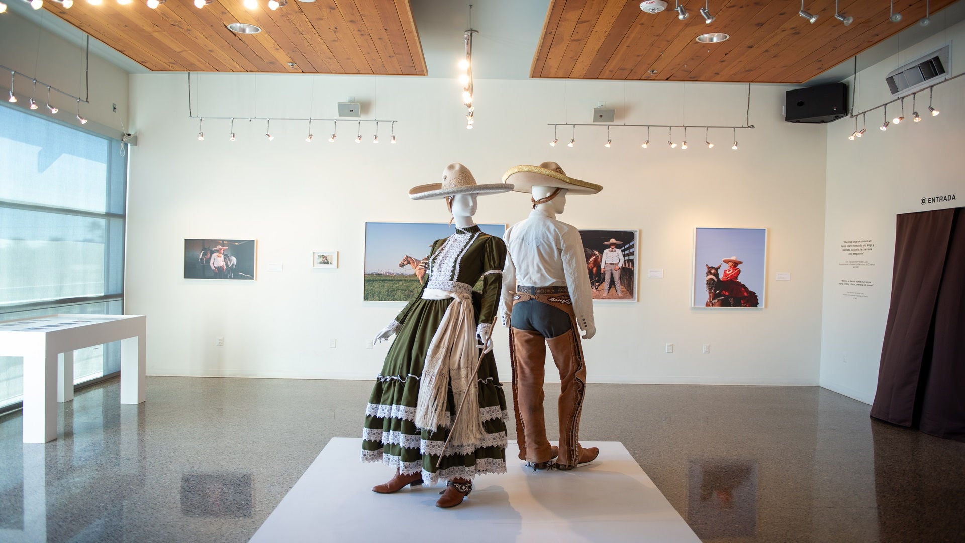 Mannequins dressed in cowboy/cowgirl attire in art exhibition 