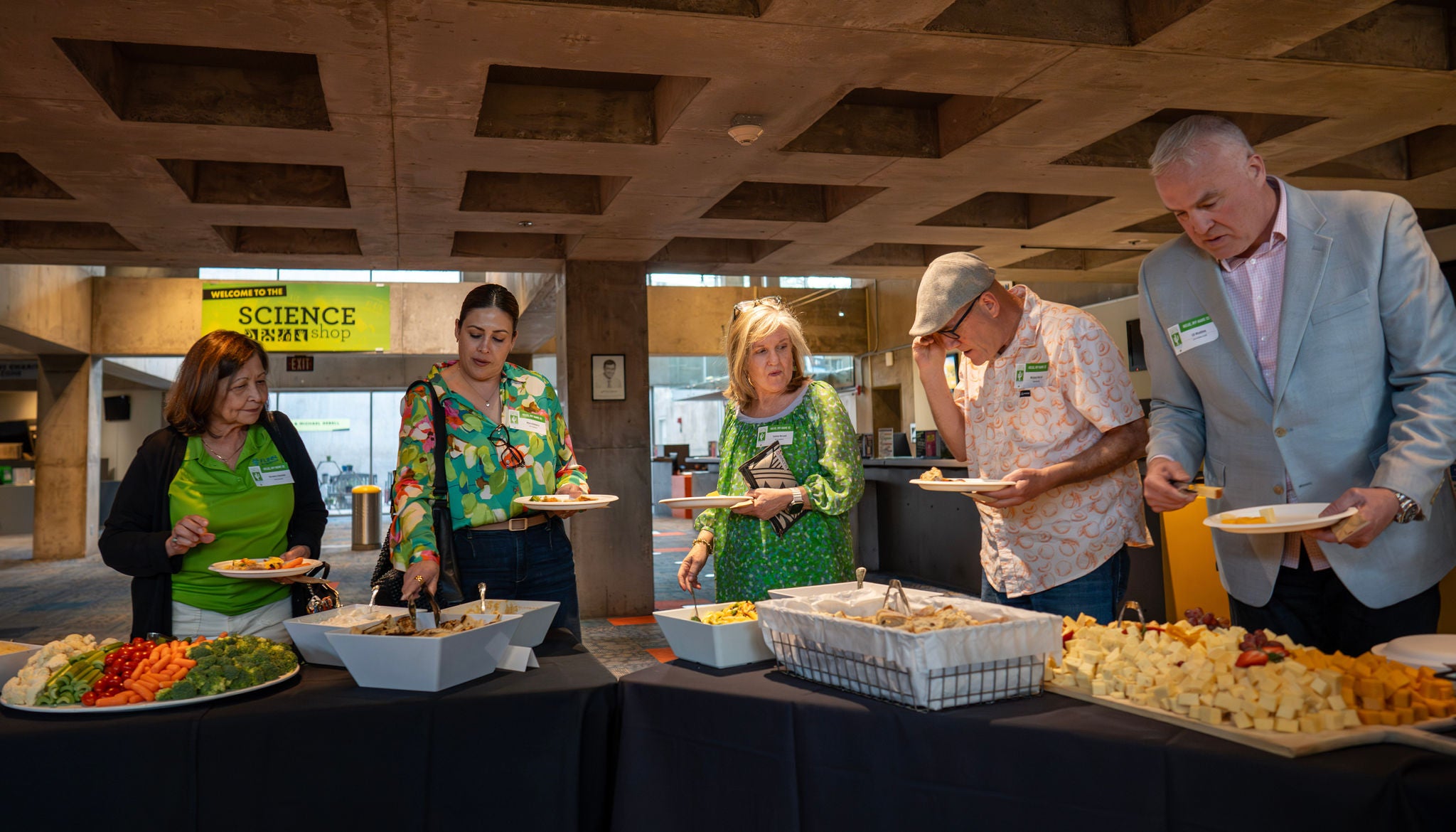 Guests serve themselves food from the dinner line.
