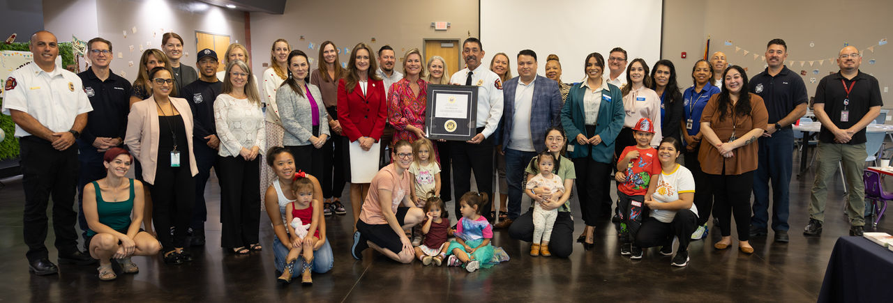 Group photo of Fire Chief Mike Duran, Vice Mayor Ann O'Brien, First Things First and their staff holding the recognition plaque.