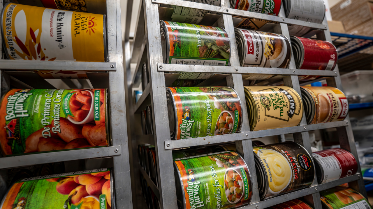 Canned food organized on shelves at a shelter.