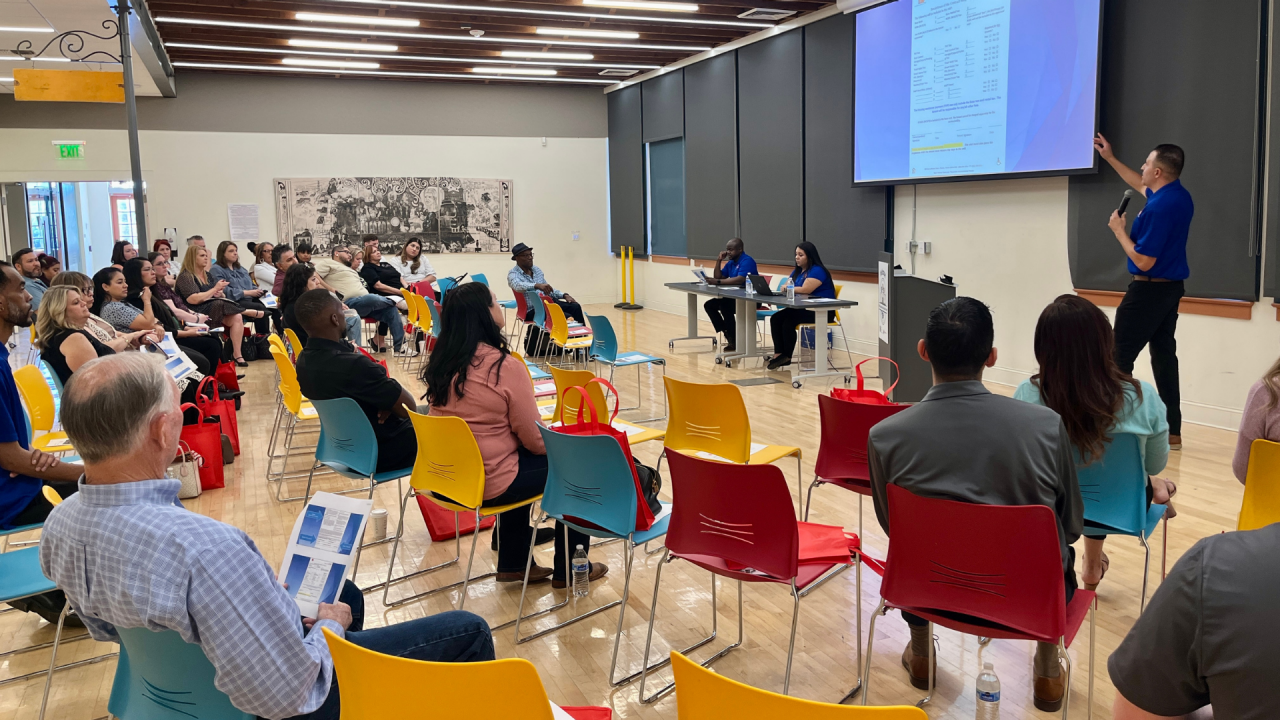 People listening to a presentation during a breakout session at a City of Phoenix Landlord Open House