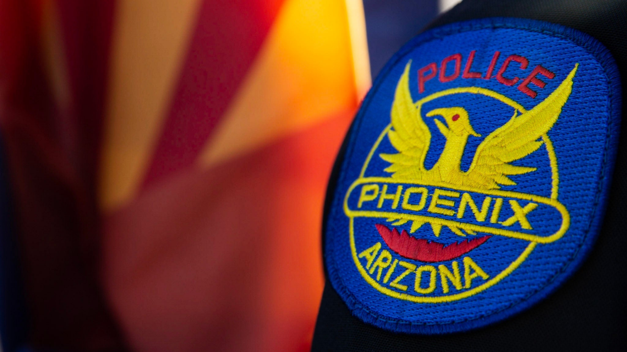 Phoenix Police patch on sleeve in front of Arizona State flag