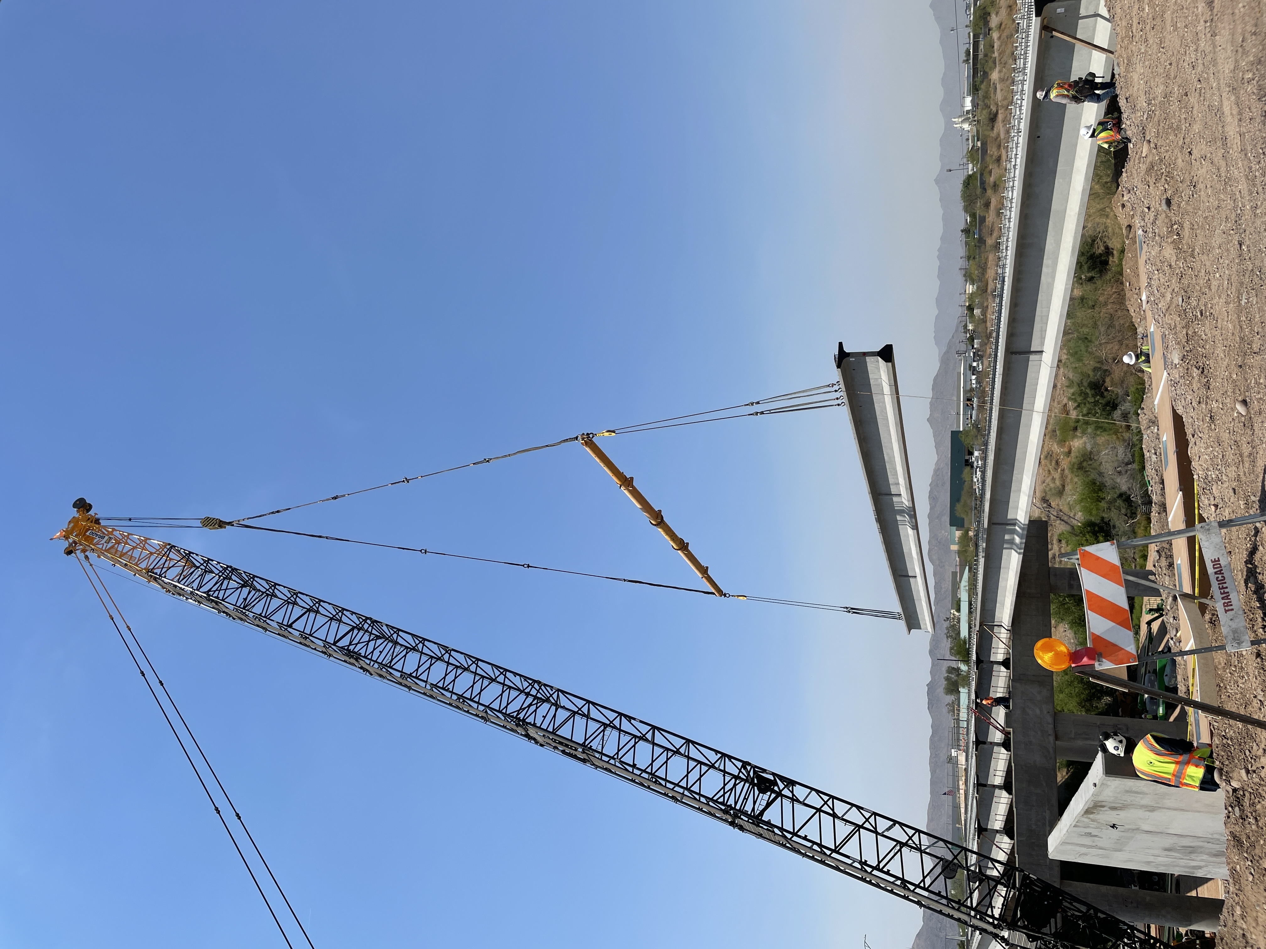 Crane lifts girder into place on north end of 7th Street Bridge over the Rio Salado riverbed