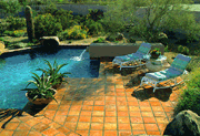 swimming pool surrounded by desert landscaping.
