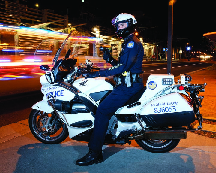 Police Reserve officer on motorcycle at night